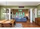 Bright living room featuring elegant columns, a fireplace, and French doors leading to an outdoor space at 9967 Devonshire St, Douglasville, GA 30135
