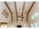 Bright living room featuring vaulted ceiling with exposed beams and multiple windows and lighting at 9967 Devonshire St, Douglasville, GA 30135