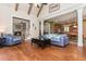 Open-concept living room with hardwood floors, a fireplace, and easy access to the kitchen and dining area at 9967 Devonshire St, Douglasville, GA 30135
