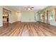 Open floor plan living room with hardwood floors, many windows, and white trim at 9967 Devonshire St, Douglasville, GA 30135