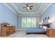 Serene main bedroom with tray ceilings, carpet, and an abundance of natural light at 9967 Devonshire St, Douglasville, GA 30135
