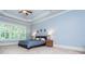 Relaxing main bedroom with trey ceilings, natural light, and carpet floors at 9967 Devonshire St, Douglasville, GA 30135