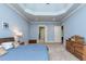 Cozy main bedroom featuring trey ceilings, carpet, and neutral paint at 9967 Devonshire St, Douglasville, GA 30135