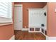 Mudroom with white hall tree, storage, and hardwood floors illuminated by window at 9967 Devonshire St, Douglasville, GA 30135
