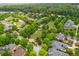 Aerial view of the neighborhood with tree-lined streets, lush green spaces, and well-maintained homes at 9967 Devonshire St, Douglasville, GA 30135