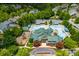 Aerial view of a community pool with a clubhouse, playground, parking lot, and lush green landscaping at 9967 Devonshire St, Douglasville, GA 30135