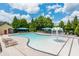 Community pool with lounge chairs, splash fountain and covered seating area under blue shade canopies at 9967 Devonshire St, Douglasville, GA 30135