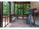 Relaxing screened porch with comfortable seating and views of the lush backyard at 9967 Devonshire St, Douglasville, GA 30135