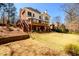 Scenic backyard showcasing a lush lawn, a wooden deck, and a well-maintained landscape, perfect for outdoor enjoyment at 1105 River Laurel Dr, Suwanee, GA 30024
