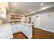 Basement bar area with granite countertops offers additional seating and backyard access at 1105 River Laurel Dr, Suwanee, GA 30024