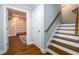 Finished basement with an open shelving system, stairs, and wood-look flooring at 1105 River Laurel Dr, Suwanee, GA 30024