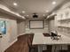 Basement with wet bar, projector screen and adjacent seating for movie nights and entertaining at 1105 River Laurel Dr, Suwanee, GA 30024