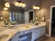 Bright bathroom with double vanity, granite counters and large mirrors at 1105 River Laurel Dr, Suwanee, GA 30024