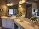 Bright bathroom with double vanity, granite counters, and decorative wall art at 1105 River Laurel Dr, Suwanee, GA 30024