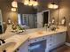 Bright bathroom with double vanity, granite counters and large mirrors at 1105 River Laurel Dr, Suwanee, GA 30024