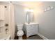 Bathroom with a white vanity, toilet, and tiled shower-tub with chrome fixtures at 1105 River Laurel Dr, Suwanee, GA 30024