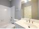 Clean bathroom featuring a shower-tub combo, white vanity, and neutral decor at 1105 River Laurel Dr, Suwanee, GA 30024