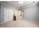 Neutral bedroom offering double closets and multiple doorways to other parts of the house at 1105 River Laurel Dr, Suwanee, GA 30024