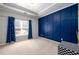 Bright bedroom features a geometric accent wall, a large window and carpeted floors at 1105 River Laurel Dr, Suwanee, GA 30024