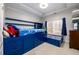 Blue themed bedroom featuring a large storage bed, and a window with natural light at 1105 River Laurel Dr, Suwanee, GA 30024