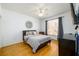 Bedroom with hardwood floors, a ceiling fan, neutral walls, and a window providing natural light at 1105 River Laurel Dr, Suwanee, GA 30024