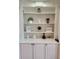 Close-up of a built-in bookcase with decorative items displayed on shelves at 1105 River Laurel Dr, Suwanee, GA 30024
