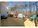 Relaxing deck area with ample seating, a grill, and string lights, perfect for outdoor entertaining and enjoying the wooded view at 1105 River Laurel Dr, Suwanee, GA 30024