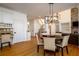 Dining room with an open floorplan and hardwood floors leading to stairs and connected living spaces at 1105 River Laurel Dr, Suwanee, GA 30024