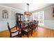 Formal dining room with hardwood floors, decorative molding, and large windows offering plenty of natural light at 1105 River Laurel Dr, Suwanee, GA 30024
