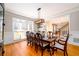 Elegant dining room with a large table, hardwood floors, and ample natural light at 1105 River Laurel Dr, Suwanee, GA 30024