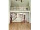 Open entryway with hardwood floors, staircase, and second floor balcony at 1105 River Laurel Dr, Suwanee, GA 30024