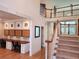 Welcoming entryway featuring a staircase, home work area with multiple desks, and a view of the bright living room at 1105 River Laurel Dr, Suwanee, GA 30024