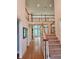 Grand entryway with stairs leading to a second-story landing and a view to the living room with many windows at 1105 River Laurel Dr, Suwanee, GA 30024