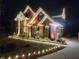 Festive brick home adorned with sparkling Christmas lights, creating a magical and inviting ambiance for the holiday season at 1105 River Laurel Dr, Suwanee, GA 30024