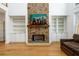 Elegant stone fireplace with built-in shelving, providing a focal point in the living space at 1105 River Laurel Dr, Suwanee, GA 30024