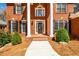 Welcoming front entrance with white pillars and a brick walkway leading to the door at 1105 River Laurel Dr, Suwanee, GA 30024