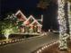 Festive brick home illuminated with holiday lights and a winding driveway at 1105 River Laurel Dr, Suwanee, GA 30024