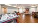 Spacious game room has wood floors, recessed lighting, and a variety of entertainment options for all ages at 1105 River Laurel Dr, Suwanee, GA 30024