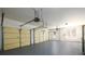 Spacious two-car garage featuring a clean floor, ample lighting, and two garage doors, ready for vehicle storage at 1105 River Laurel Dr, Suwanee, GA 30024