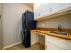 Functional laundry room featuring stacked washer and dryer and built in cabinets at 1105 River Laurel Dr, Suwanee, GA 30024