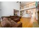 Open concept living room featuring a stone fireplace, staircase, and connection to the kitchen at 1105 River Laurel Dr, Suwanee, GA 30024