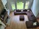 Bright living room with a stone fireplace, hardwood floors, and a comfortable sectional sofa at 1105 River Laurel Dr, Suwanee, GA 30024
