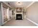 Cozy living room featuring a fireplace with built-in shelving and a sunlit window at 1105 River Laurel Dr, Suwanee, GA 30024