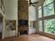 Bright living room featuring stone fireplace, hardwood floors, and large windows at 1105 River Laurel Dr, Suwanee, GA 30024
