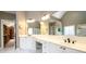 Spacious main bathroom with dual vanities, white cabinetry, and walk-in closet access at 1105 River Laurel Dr, Suwanee, GA 30024