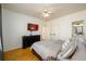 Main bedroom with hardwood floors, neutral walls, a ceiling fan, and a modern dresser at 1105 River Laurel Dr, Suwanee, GA 30024