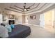 Spacious main bedroom boasts a tray ceiling, fireplace, built-ins, and plenty of natural light at 1105 River Laurel Dr, Suwanee, GA 30024