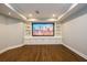 Finished basement media room features built in shelving and large television, perfect for entertaining at 1105 River Laurel Dr, Suwanee, GA 30024