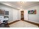 Home office features hardwood floors, modern lighting, and a television for a comfortable workspace at 1105 River Laurel Dr, Suwanee, GA 30024