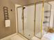 Enclosed tiled shower with glass doors and gold trim at 1105 River Laurel Dr, Suwanee, GA 30024